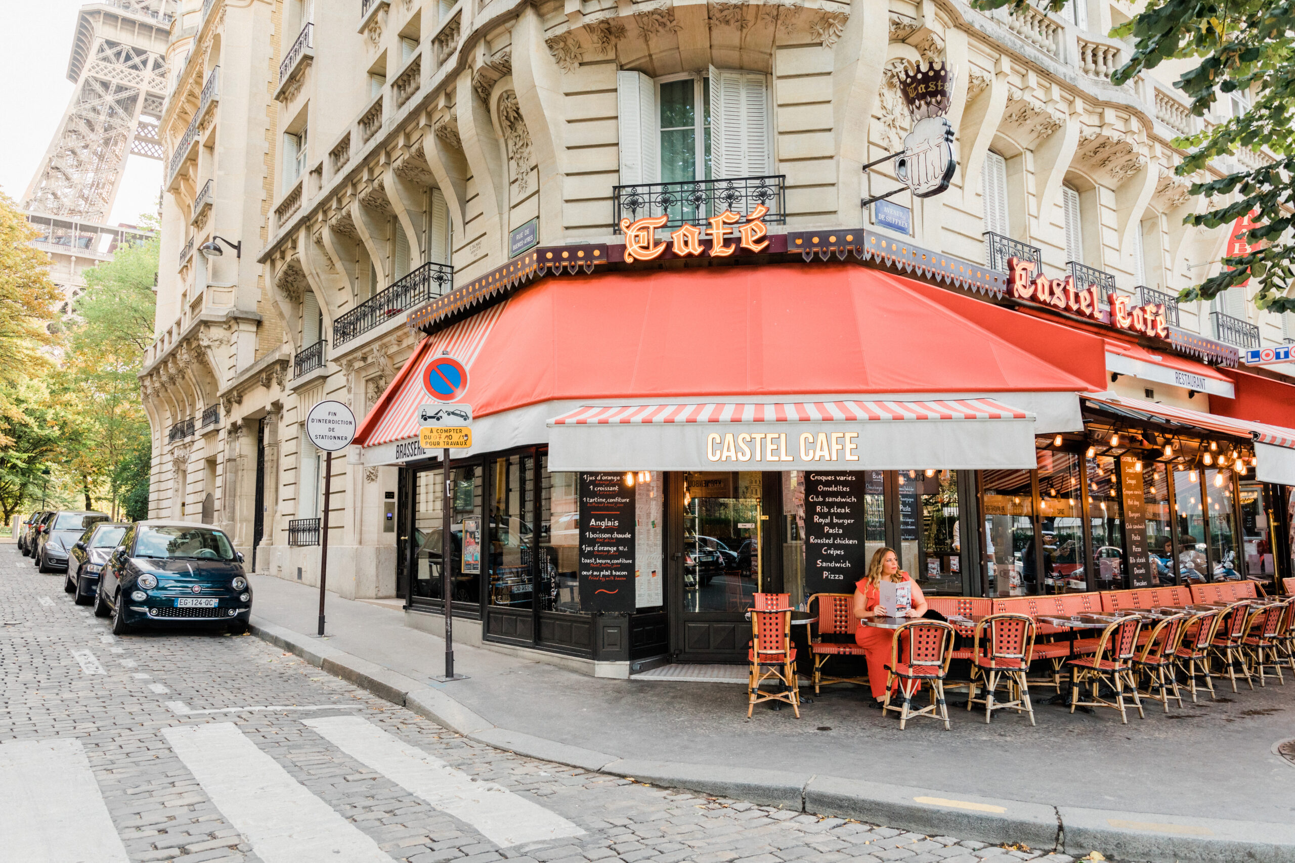 girl in red sitting at Paris cafe