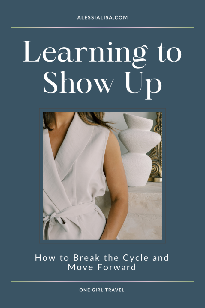 A woman in a light gray sleeveless wrap top stands beside minimalist ceramic vases. Text reads “Learning to Show Up: How to Break the Cycle and Move Forward” from AlessiaLisa.com and One Girl Travel.