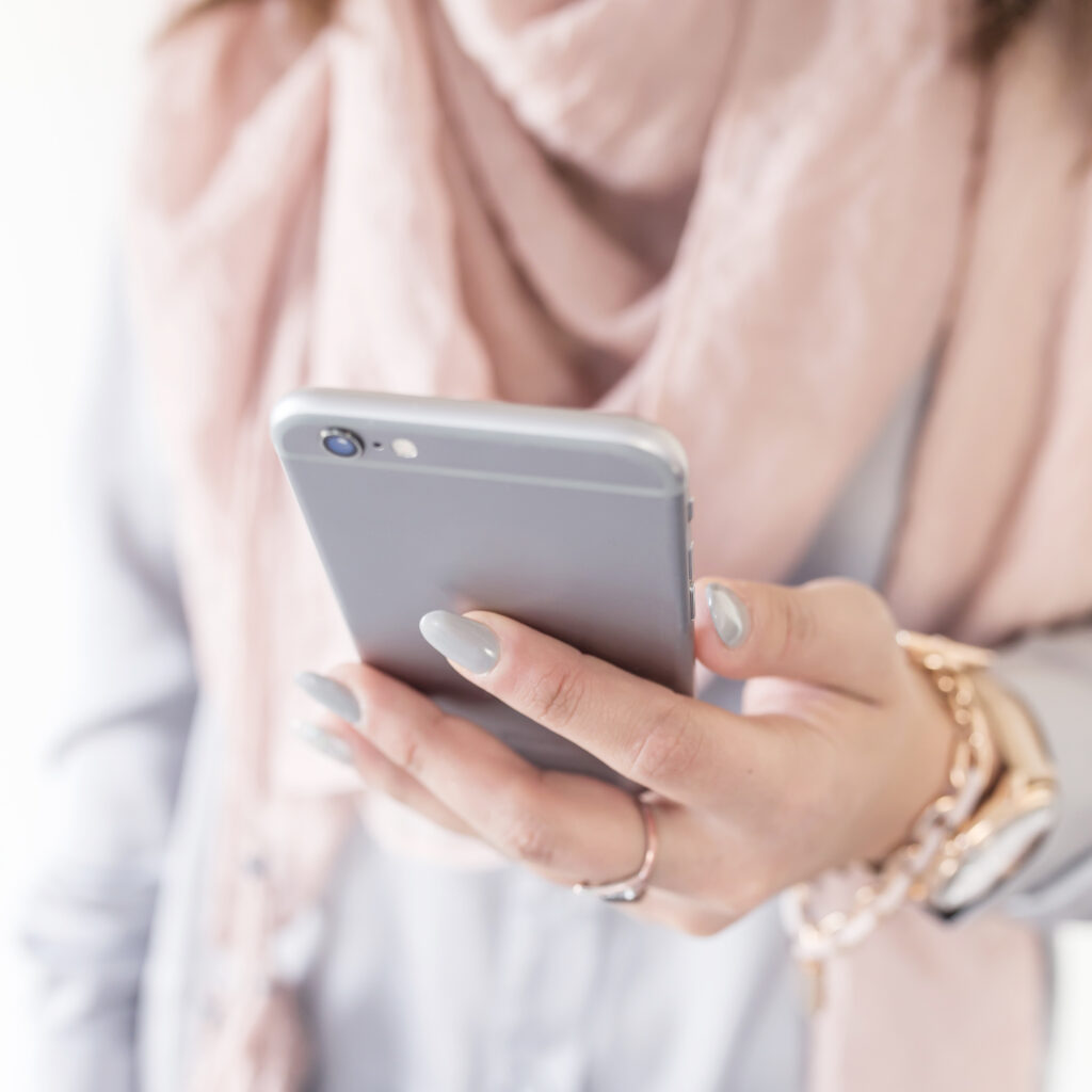 Woman in her early 50s on her phone traveling solo